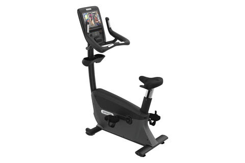 Black upright stationary exercise bike with digital console display, curved handlebars, and padded seat on white background