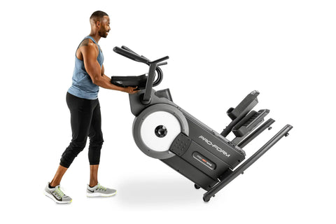 Black and white ProForm Pro HIIT H14 elliptical machine with digital display, ergonomic handles, and footrest on white backgr