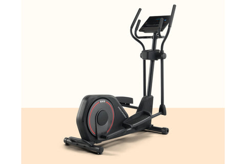 Black elliptical machine with red accent trim, digital display console, curved handles, and footplate on white background