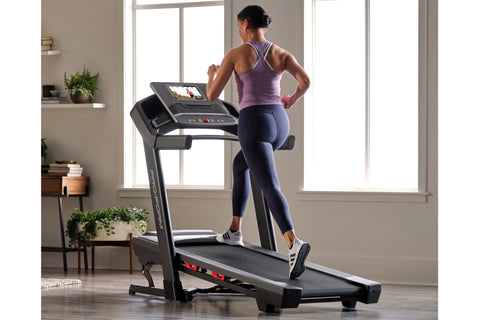 Black ProForm Trainer 1000 treadmill with digital display console, red accents, and cushioned running deck on white backgroun