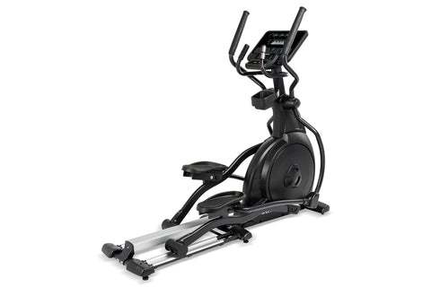 Black elliptical machine with digital console, dual handles, and silver foot pedals on white background