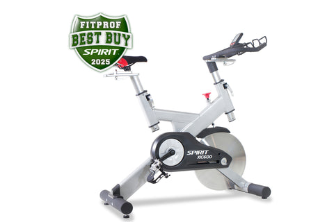Spirit XIC600 indoor stationary bike with white frame, black seat and handlebars, featuring flywheel on white background with