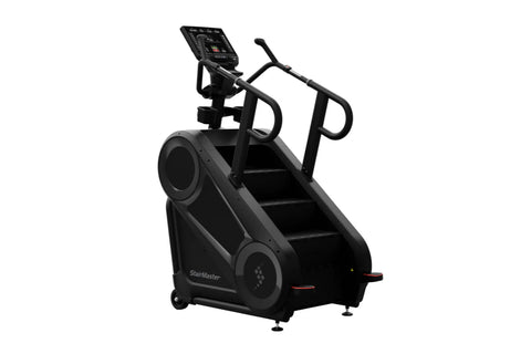 Black StairMaster 8Gx Gauntlet stair stepper with digital display, handrails, and stepped platform on white background