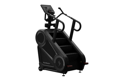 Black StairMaster 8Gx Gauntlet stair stepper with digital display, handrails, and stepped platform on white background