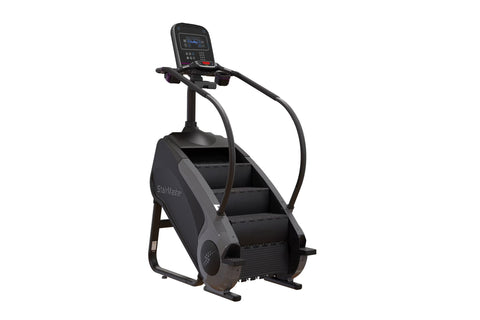 Black StairMaster Gauntlet 8G StepMill with digital display console, handrails, and stepped climbing platform on white backgr