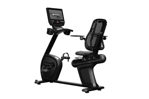 Black Star Trac recumbent exercise bike with integrated touchscreen display, mesh back support, and pedal platform on white b