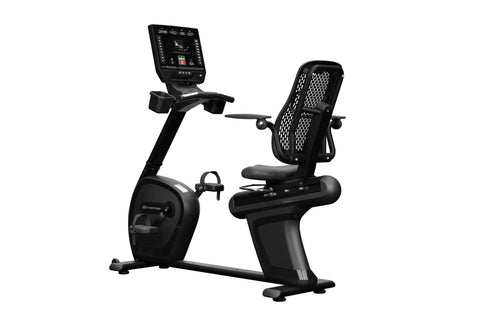 Black Star Trac recumbent exercise bike with integrated touchscreen display, mesh back support, and pedal platform on white b