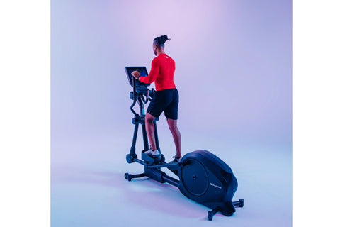 Black Star Trac elliptical cross trainer with digital display console, dual handles, and large wheel base on white background
