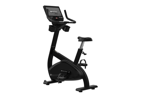 Black upright stationary bike with digital console display, handlebar grips, adjustable seat, and foot pedals on white backgr
