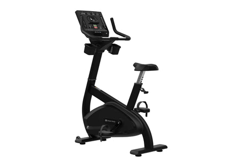 Black upright stationary bike with digital console display, handlebar grips, adjustable seat, and foot pedals on white backgr