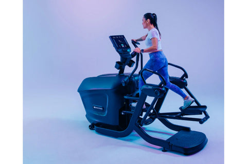 Black Star Trac elliptical machine with digital console, dual handles, and footplates on white background