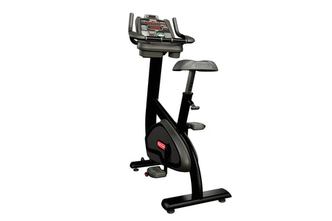 Star Trac SUBx upright exercise bike with black frame, gray seat, and digital console on white background