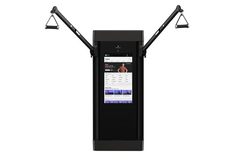 Black Tonal 2 smart home gym with dual articulating arms and grip handles, touchscreen display showing fitness app interface,