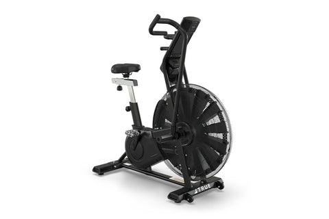 Black TRUE ADX exercise air bike with large fan wheel, digital display console, curved handlebars, black cushioned seat, and 