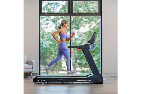 True Performance 8000 black treadmill with digital touchscreen display, cushioned running deck, and integrated control consol
