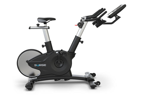 Black and silver upright exercise bike with digital display console, handlebars, and cushioned seat on white background