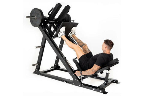 Black and silver leg press hack squat machine with padded backrest, footplate, and dual shoulder supports on white background