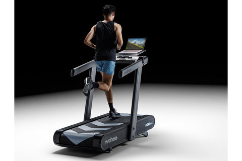 Wahoo KICKR RUN smart treadmill with black frame, digital display console, and cushioned running deck on white background