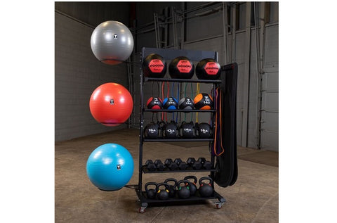 Black multi-tier storage rack holding exercise balls in silver, red, and blue, medicine balls, dumbbells, and kettlebells in 