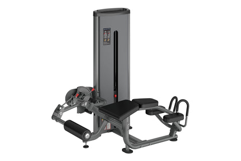 Warrior Deluxe Commercial Series Prone Leg Curl machine with gray steel frame, black padding, and leg extension attachment on