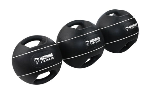 Three black Warrior Strength medicine balls with dual grip handles and white stripe detail on white background