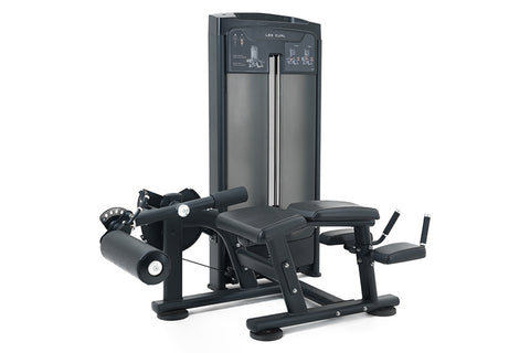 Warrior Elite commercial leg curl machine with black upholstered seat and footrest, metal frame, weight stack, and control pa