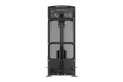 Black commercial standing rear kick machine with padded footplate and curved handles on white background