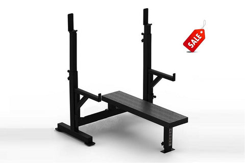 Black adjustable weight bench with barbell rack and safety spotter arms on white background