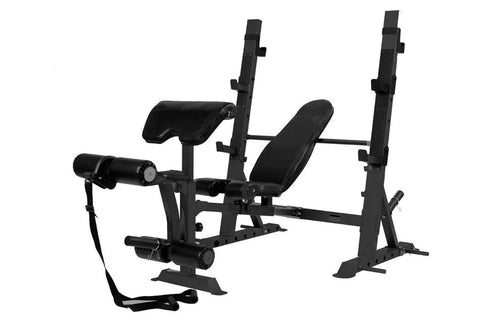 Black multi-function Olympic weight bench with adjustable backrest, leg extension attachment, and safety racks on white backg