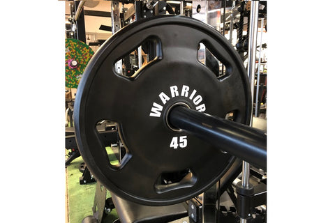 Black rubber Olympic weight plate with "Warrior" branding and "45" marking, dual handles, displayed front-facing