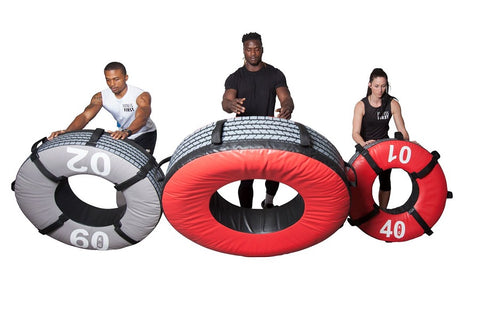Three weighted exercise tires in gray 60 lb, red 90 lb, and red 40 lb sizes, each held by a model demonstrating use on white 