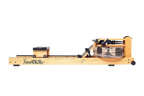 WaterRower Xeno Muller Signature Edition rowing machine with natural wood frame, black mechanical components, and water resis