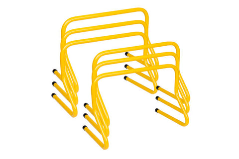 Set of yellow weighted training hurdles with black foot pegs, stacked arrangement on white background