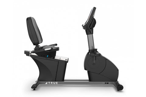 TRUE CS400 commercial recumbent stationary bike with black seat and frame, digital display console, and foot pedals on white 