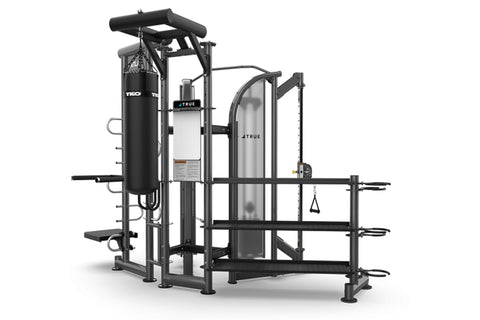 Black and silver multi-station gym equipment with punching bag, leg press, and cable machine on white background