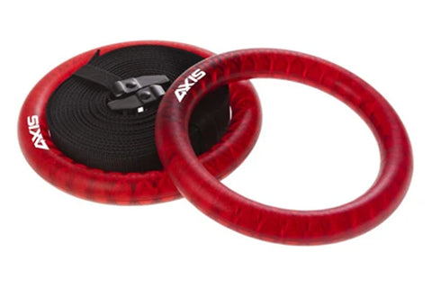 Red velvet gym rings with black webbing straps and metal buckles, displayed on white background