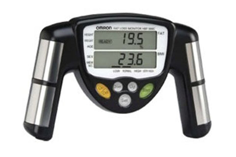 Omron body fat monitor with black and silver handles, digital display showing readings, and yellow and green buttons on white