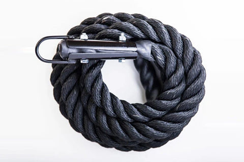 Black twisted climbing rope coiled with metal carabiner attachment on white background