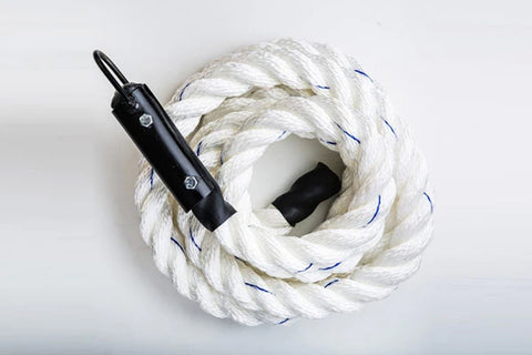 Warrior Climbing Rope in white with blue tracer strands and black handle grip, coiled on white background
