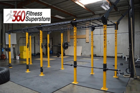 Warrior Commercial Pro Advanced heavy-duty pull-up rig with yellow uprights, black horizontal bars, and multiple attachment p