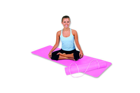 Woman in light blue tank top and black leggings sitting cross-legged on bright pink folded yoga mat with carrying strap