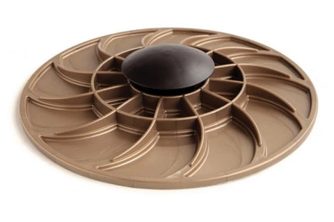 Gold and black circular balance board with multiple curved ridges and central dome knob, flat lay on white background