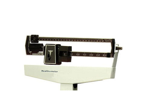 Health-O-Meter mechanical balance scale with cream base, black top bar with numbered weight dial, and caduceus medical symbol