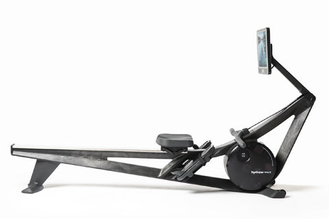 Black Hydrow Wave rowing machine with digital touchscreen monitor displaying water rowing simulation, on white background