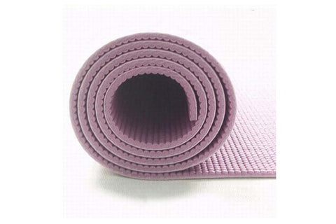 Rolled mauve and cream yoga mat showing textured surface and layered construction