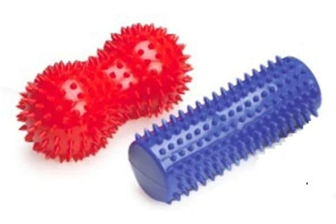 Red spiky massage peanuts and blue ridged massage roller on white background