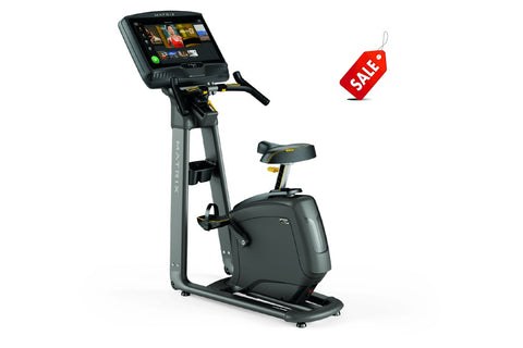 Matrix U50 upright exercise bike with gray frame, black seat, and digital display console on white background