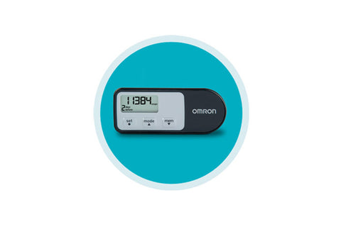 Omron digital pedometer with white LCD display showing step count, black and white body, set on turquoise circular background