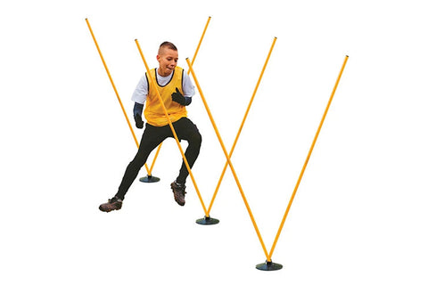 Athlete wearing yellow training vest and black pants using yellow agility poles in zigzag drill formation on white background