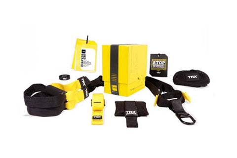 TRX Suspension Trainer system with yellow and black straps, anchor strap, door anchor, resistance bands, and carrying case on